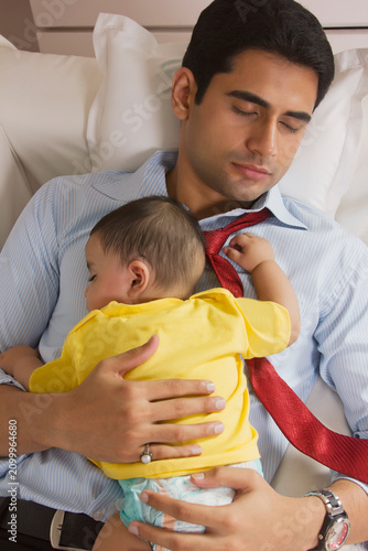 Father and baby sleeping