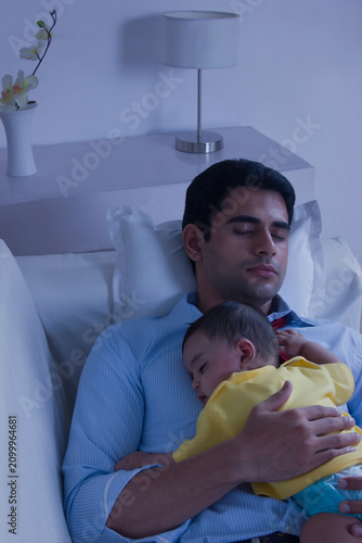 Father and baby sleeping