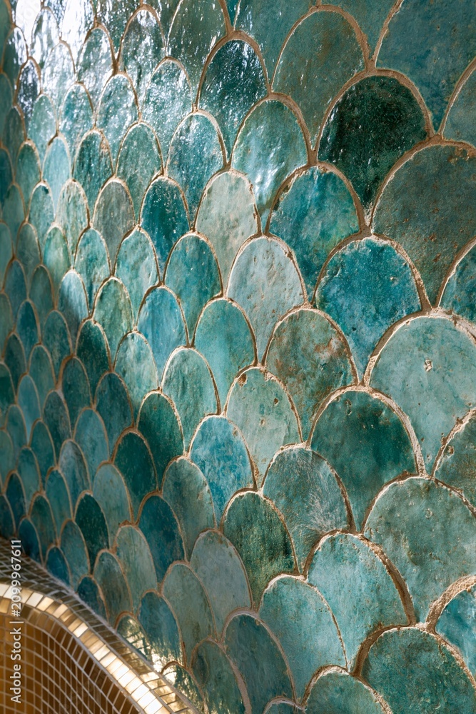 Obraz premium Closeup of hand-crafted emerald zellige tile wall with irregular edges and natural color variations in a contemporary Moroccan bathroom setting