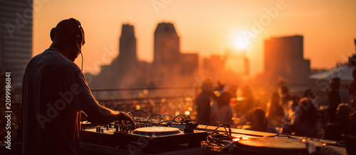 DJ performing in rooftop at sunset