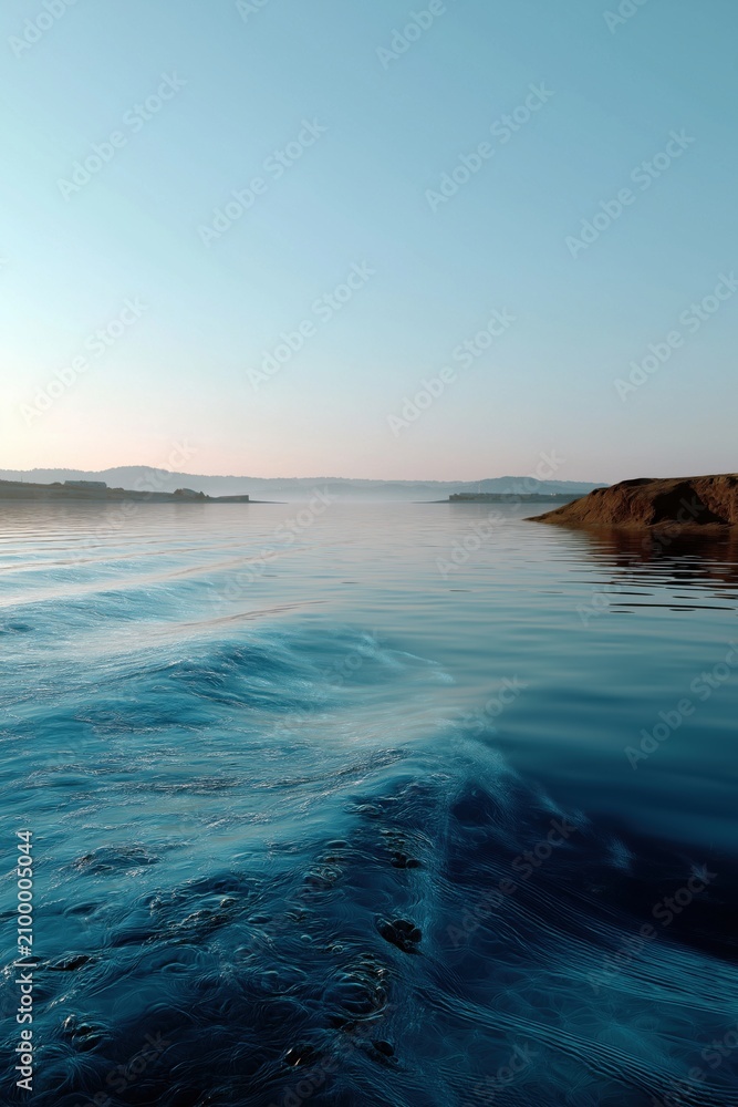 Obraz premium Calm water waves rise and fall near the coastline at dusk during a quiet evening in a coastal area