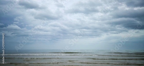 Gloomy Ocean Horizon in Rainy Season, Dark Overcast Sky Over Calm Sea, Moody Gray Sea Under Stormy Clouds, Mental Health Metaphor Background.