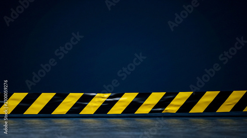 Yellow-black hazard warning tape horizontal strip lower clean dark navy upper, incident response