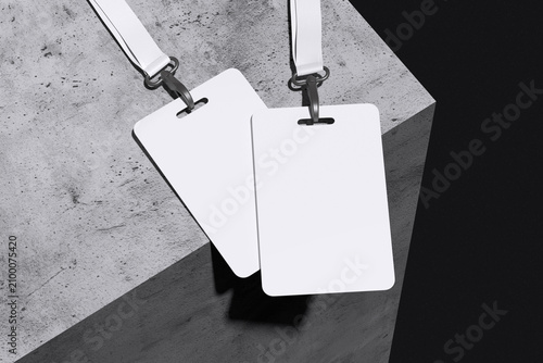 Two white ID card badge with lanyard on concrete and black background for mockup template