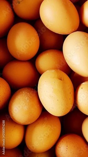 Fresh brown chicken eggs create an abundant natural food background at a local market.