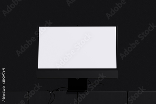 White screen desktop monitor on black table with cable and dark background for mockup template