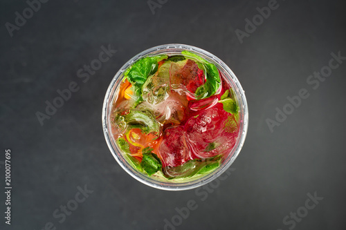 Top view of strawberry lemonade with mint. Fresh strawberry lemonade with ice cubes and mint leaves photographed from above. Summer beverage concept.