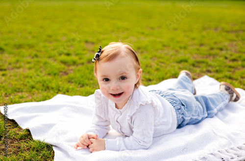 Foto Cute Little Girl in Easter Bunny Costume Walking in Spring Park, Happy Child Cel