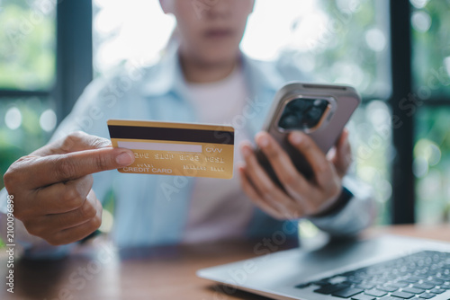Digital payment report and mobile banking concept woman holding credit card using smartphone for online shopping e-commerce financial transaction secure cashless transfer technology modern lifestyle