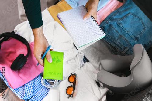 Fotografie traveler is packing a suitcase for a summer vacation