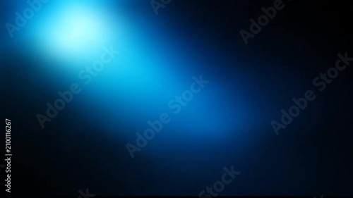 Abstract blue light beam illuminating a dark background, creating a vibrant luminous glow with atmospheric blurry lens flare effect.