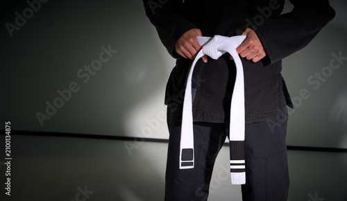 Obraz na płótnie Martial artist holding white belt for brazilian jiu jitsu