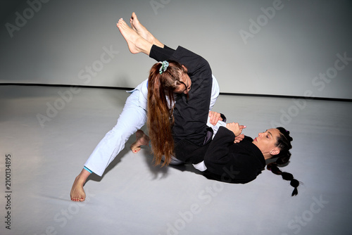 Women training brazilian jiu jitsu grappling martial arts