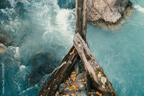 Canvastavla Wooden bridge piers and crystal clear stream in Kanas, Xinjiang, China, surround