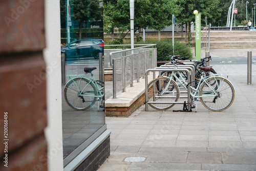 Corby, Northamptonshire, United Kingdom - July 15, 2026: Bicycles parked at modern bike rack in urban city center