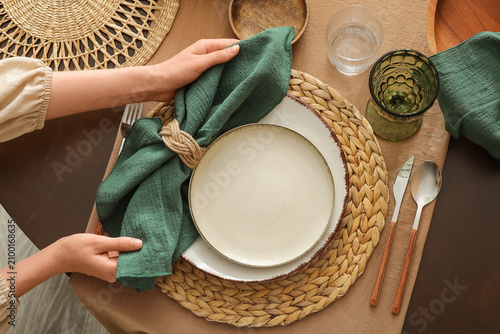 Woman setting a rustic tabl...