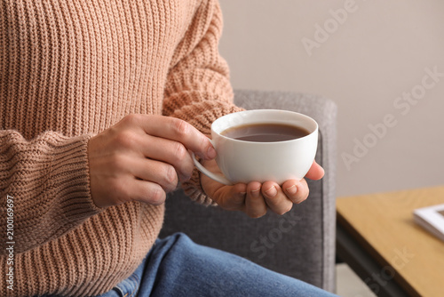 Woman in a cozy knitted swe...