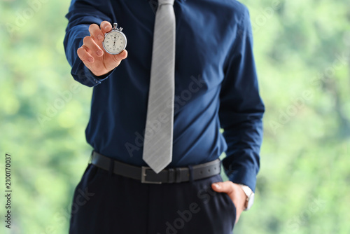 Businessman holding a stopw...