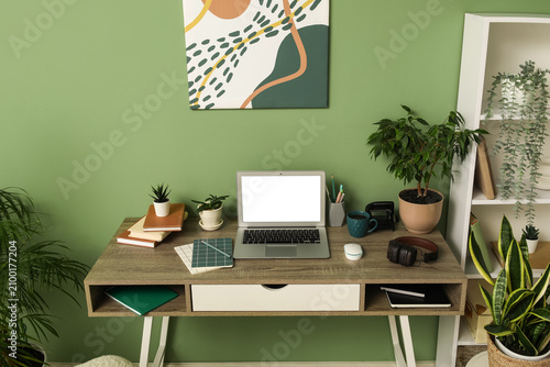 Stylish workplace with lapt...