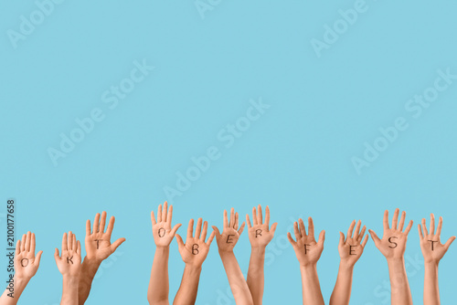 Many hands with word OKTOBE...