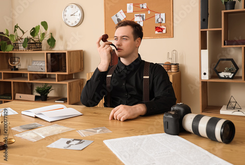Male detective smoking pipe...