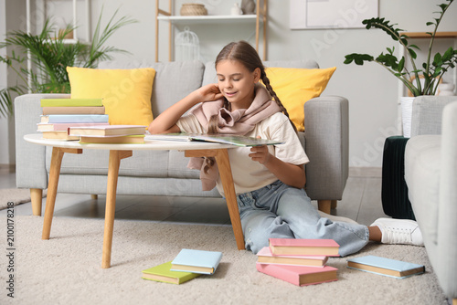 Cute schoolgirl reading boo...