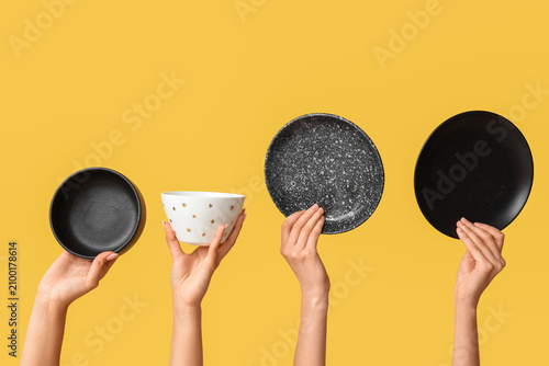 Hands holding empty plates ...