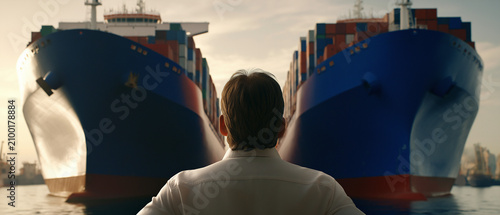 Maritime Vision: A lone figure stands between two colossal cargo ships in a harbor, gazing forward with a sense of anticipation and global reach in this dramatic scene.