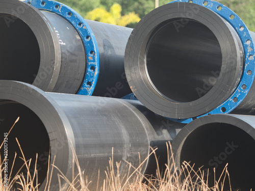Fotografie High-density polyethylene (HDPE) or steel pipes are used for high-pressure water supply these blue, flanged and bolted pipes are installed both above and below ground