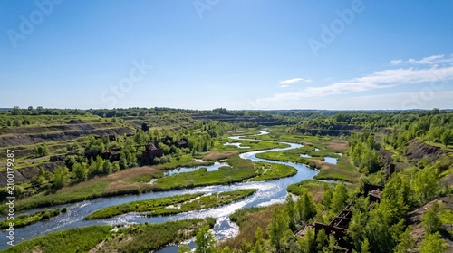 Aerial View of Winding River through Lush Green Valley Forest