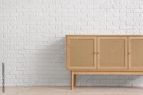 Wooden cabinet near white b...