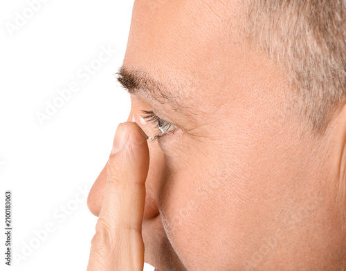 Mature man putting in conta...