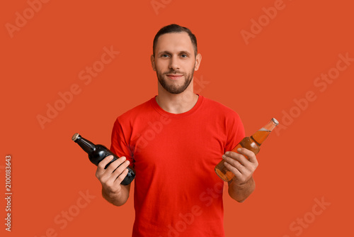 Young man with bottles of c...