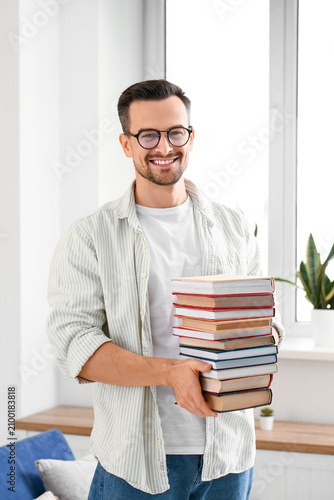 Handsome man with stack of ...