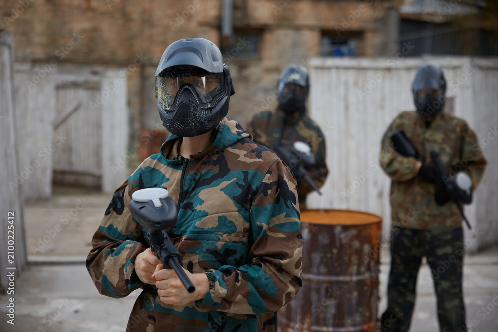 Fototapeta premium An armed group of several soldiers practice with weapons on a training field