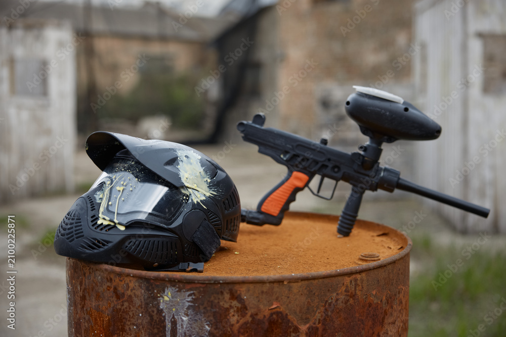 Fototapeta premium Military weapon and a helmet are placed on the barrel at the training field