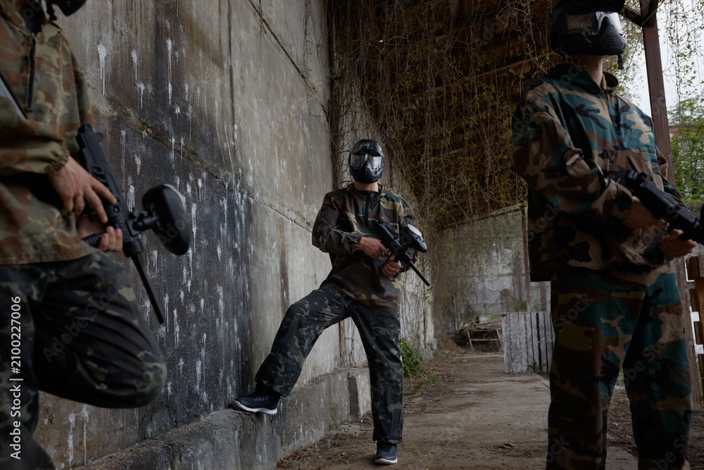 Fototapeta premium An armed group of several soldiers resting from practice with weapons on a training field