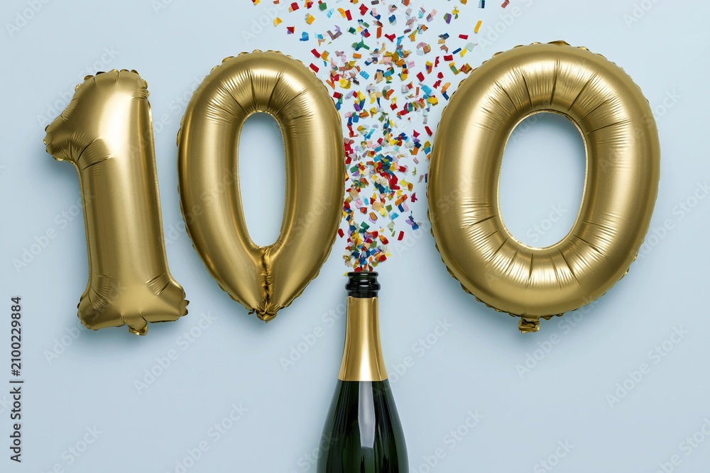 Fototapeta premium The Hundred Gold Balloons Celebration Above Sparkling Champagne Bottle with Confetti