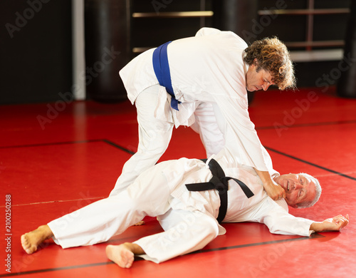 Fotografía Karate with two male athletes practicing, training and sparring in fight class