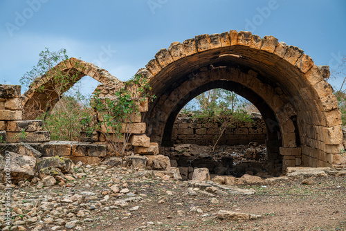 Ruins of ancient structures in Ptolemais, Libya showcase stone arches and remnants of historical architecture