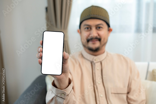 Close-up of a person holding a mobile phone with an empty screen, perfect for application display, advertisement design, and template mockup.