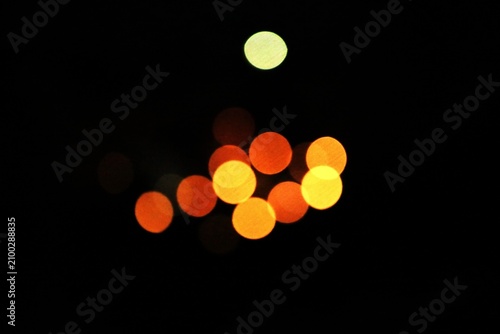 Фотография The distant lights of a night city appear as soft spots