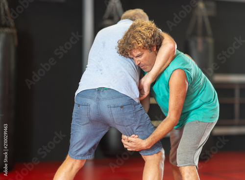 Quadro su tela Purposeful male pupil clash with training manager during self-defense lesson, re