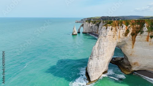 Etretat on Normandy coast, France, famous travel destination with iconic cliffs, natural arch and coastal scenery. Aerial view
