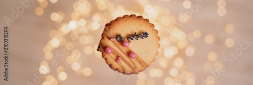 Heart shaped cookie with lavender on golden bokeh background