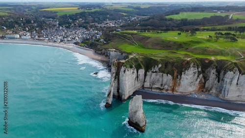 Etretat on Normandy coast, France, famous travel destination with iconic cliffs, natural arch and coastal scenery. Aerial view
