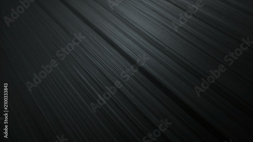 Abstract dark grey and black background with smooth diagonal speed lines and subtle metallic texture.