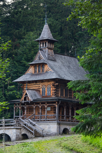 Chapel of the Sacred Heart of Jesus in wood architecture in Jaszczurowka district surrounded by trees in Zakopane area of Poland