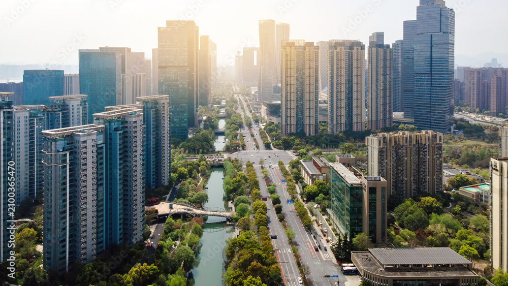 Obraz premium Modern Urban Skyline With River and Tree-lined Avenue