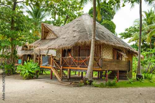 Cottages with thatched roofs and wooden structures in tropical surroundings on Koh Jum Island in Krabi Thailand